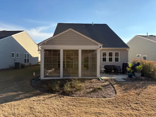 Sunspace sunroom glass panel walls shingle roof backyard suburban home