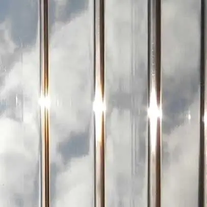 Close-up of a bronze-tinted acrylic panel with vertical ribbed detailing, showcasing its warm hue and light-filtering properties.