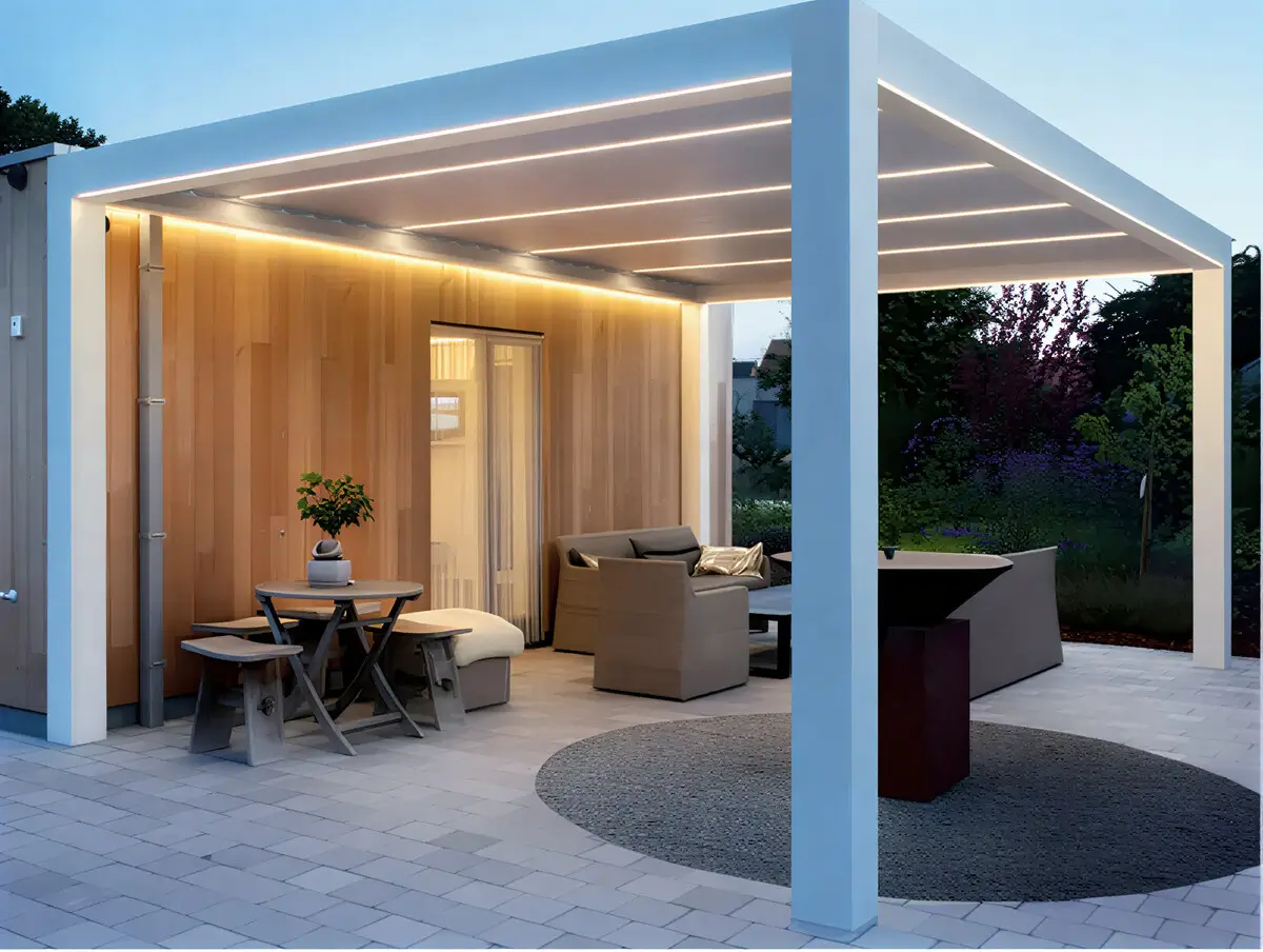 Elegant modern white pergola with integrated lighting illuminating an outdoor dining patio at twilight