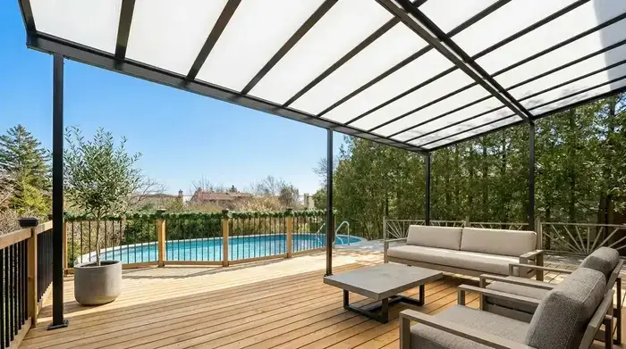 Solid insulated patio covers installed over a backyard concrete slab with comfortable outdoor furniture