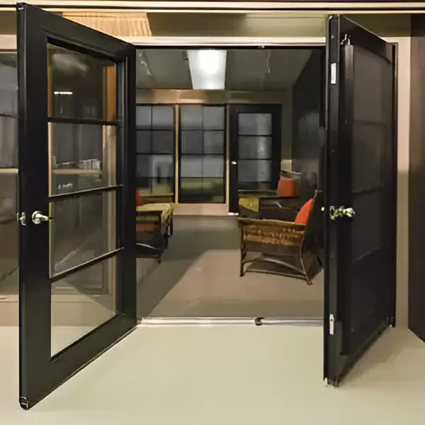 A pair of black framed WeatherMaster doors opening into a sunroom.